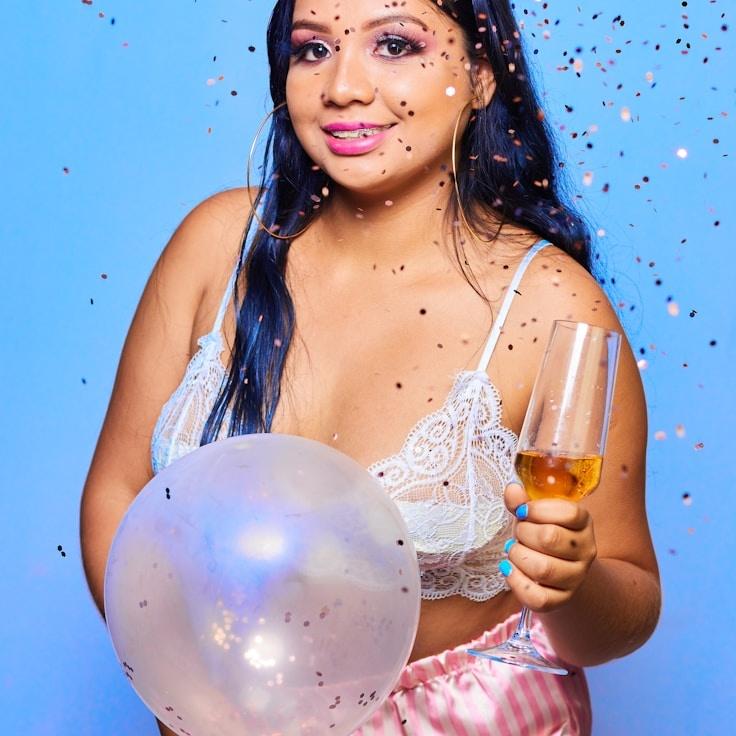 Kaveri Mehta, Lead Design Curator at Meadow River Connection, reviewing corporate floral arrangements